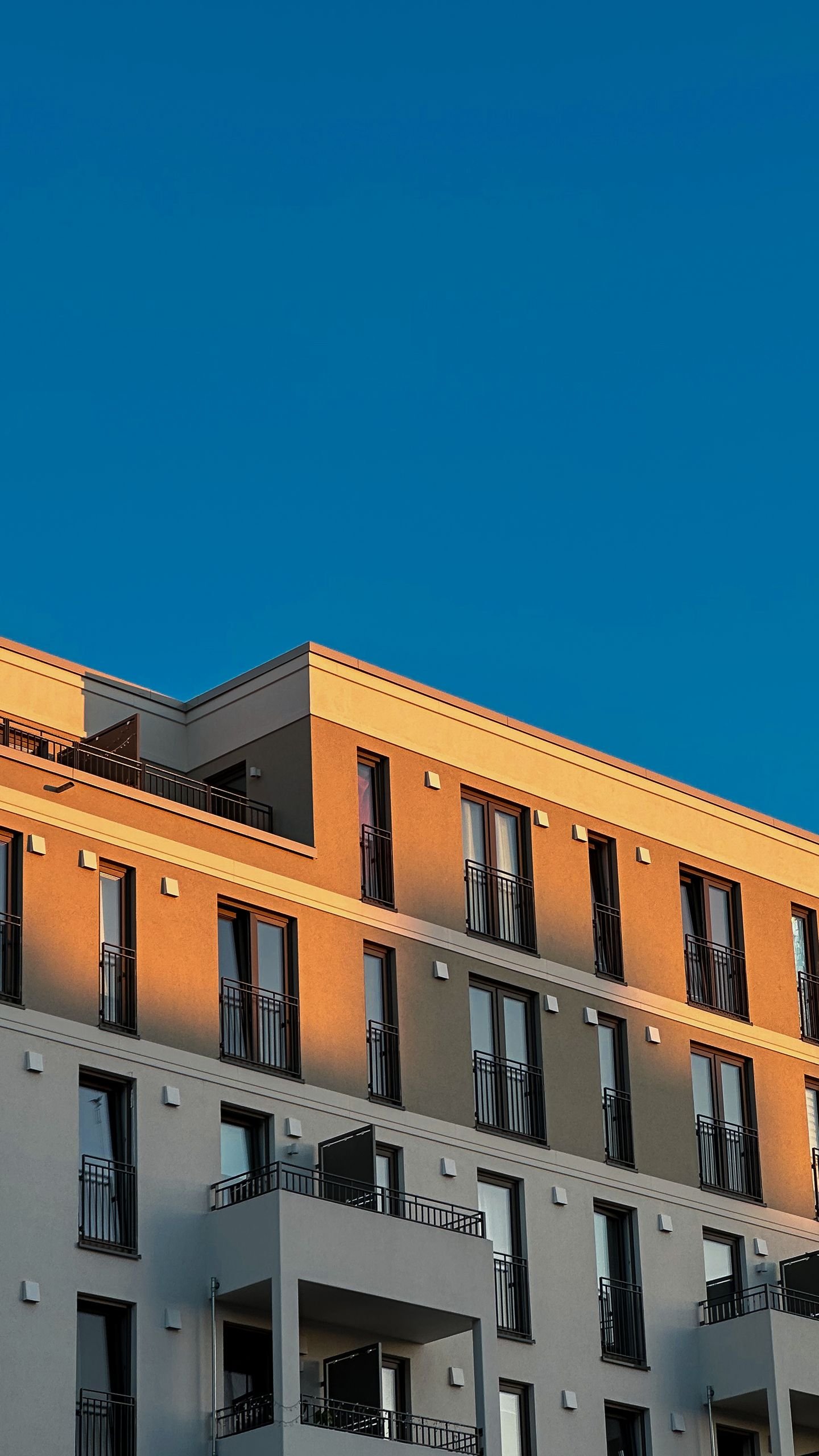 Contemporary Berlin apartment building under a clear blue sky.